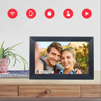 Digital photo frame displaying a couple's photo with icons indicating features like WiFi and app usage on a light gray background.